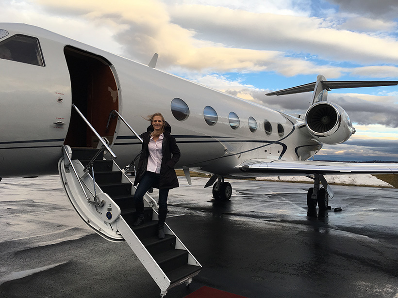 Madeleine Gilad on the steps of a jet