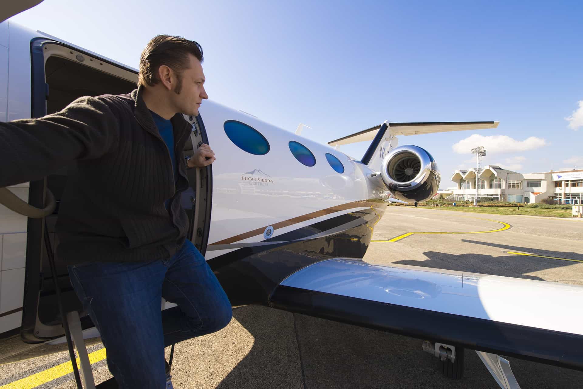 man stepping out of a private plane